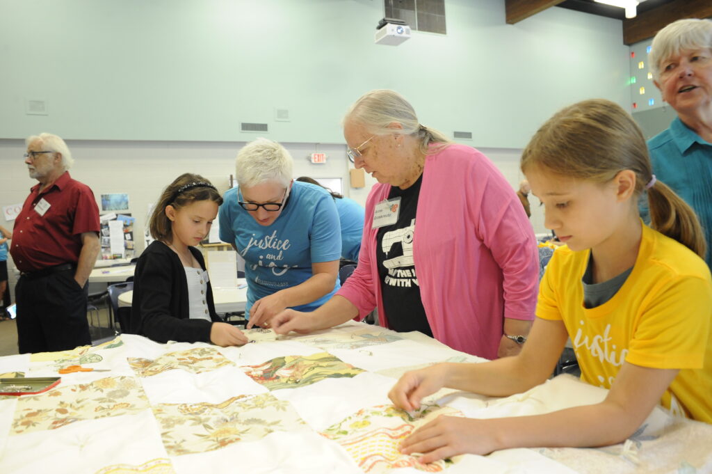 people assembling a quilt