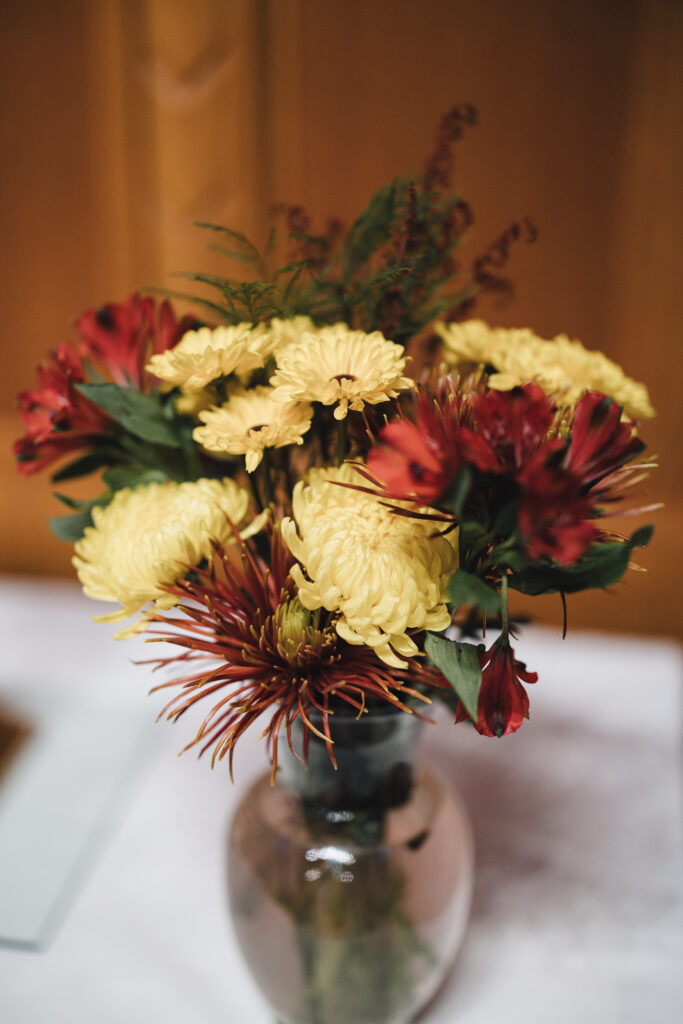 vase of yellow and red flowers